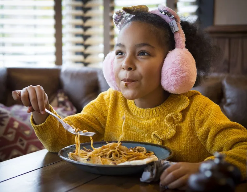 Young girl eating spaghetti