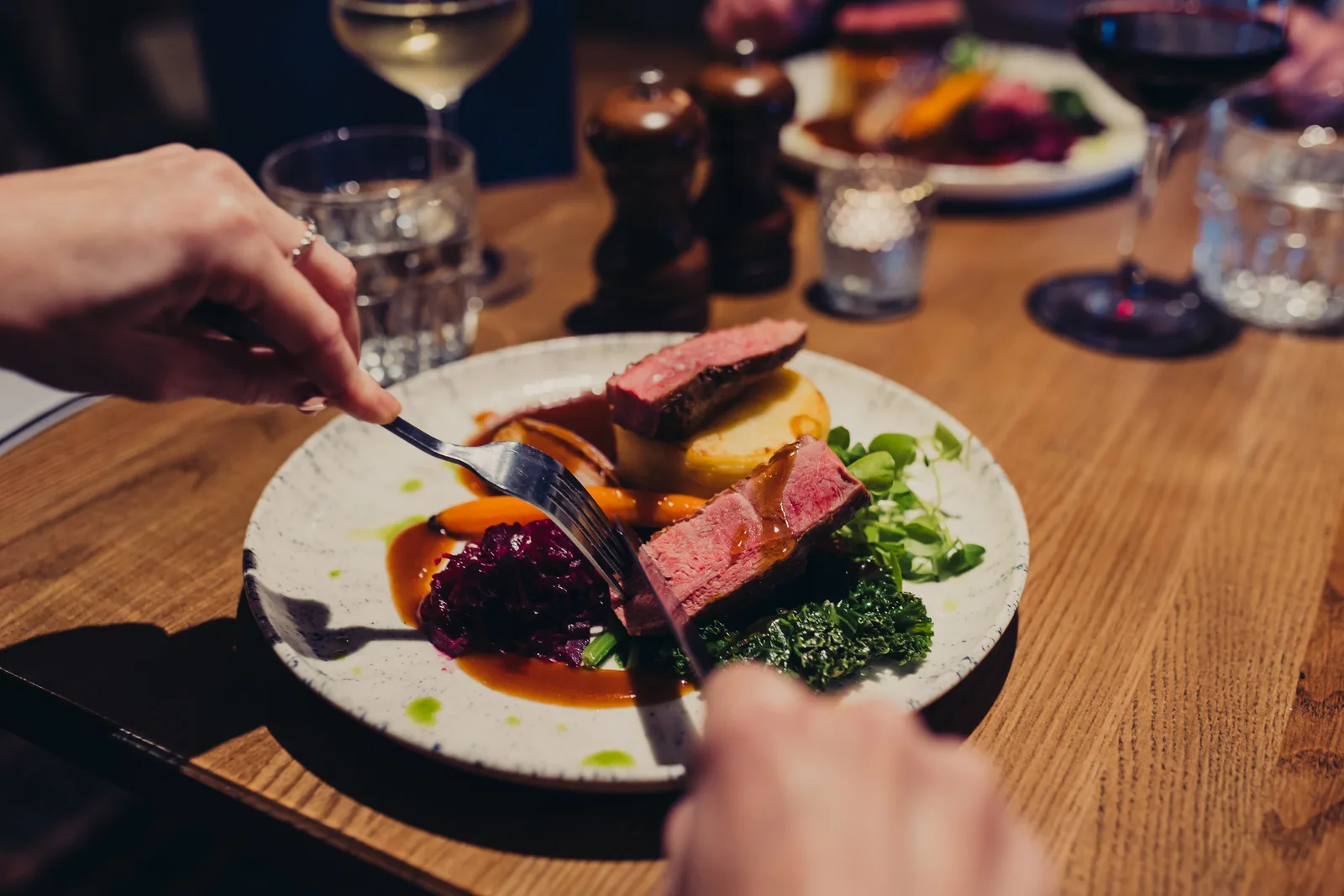 Someone cutting into Duck Breast