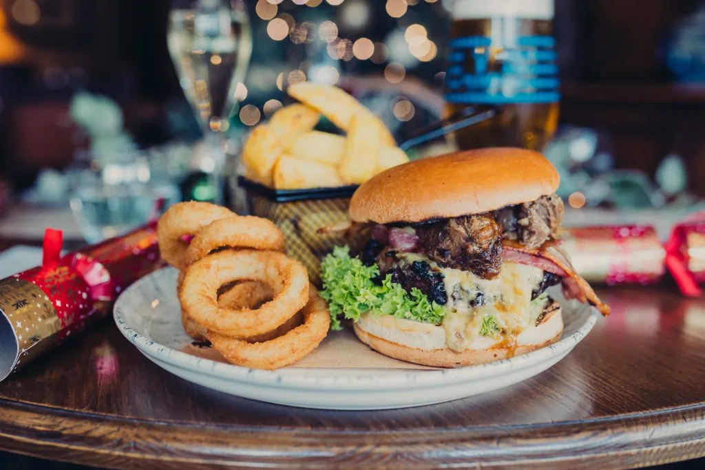 Beef Burger, Onion Rings and Chips on a plate