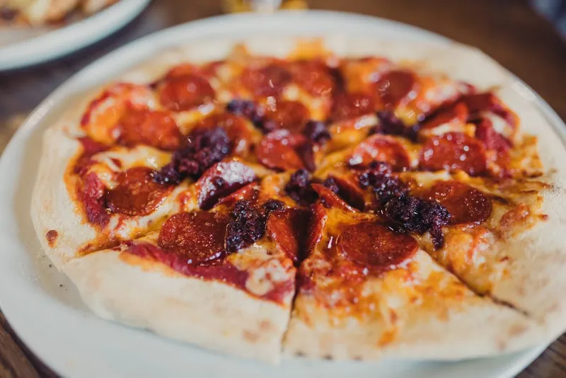 Peperoni pizza that is sliced up